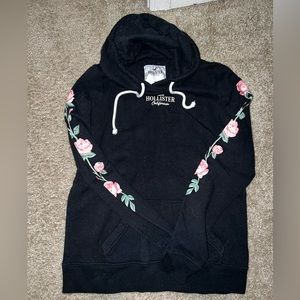 Hollister hoody with roses printed in the arm section. Good condition size XS